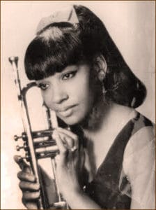 Young Clora Bryant with a trumpet