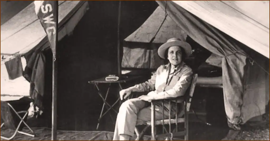 Shown in her tent, mountain climbing adventurer Gertrude Benham relaxes before an ascent.