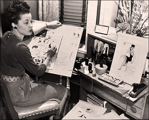 Jackie Ormes in her office drawing a cartoon.