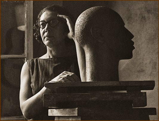 Sculptor works on sculpture of a Black man's head