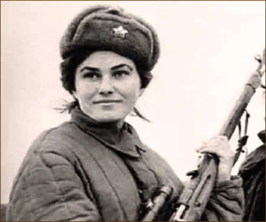 Ukranian World War II hero Lyudmila Pavlichenko with hat and rifle.