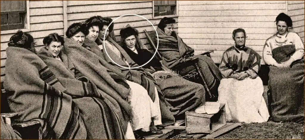 Photograph of Mary Mallon sitting outside with other residents of the Riverside Hospital.